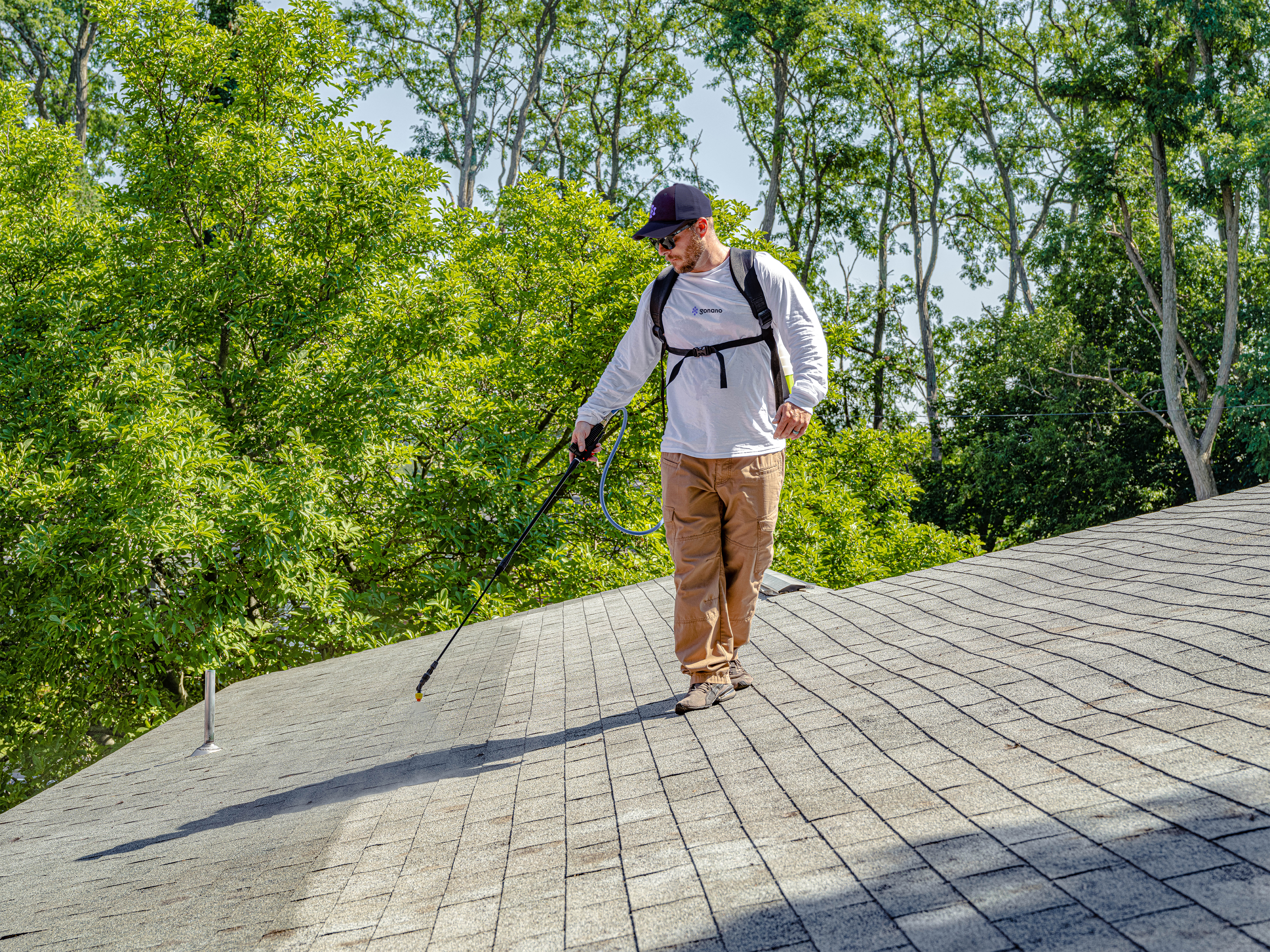 Blue Ridge NanoGuard inspector on a residential roof checking shingle condition during a free inspection